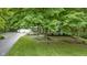 Landscaped home featuring a covered front porch, attached two-car garage, and mature shade trees at 10808 Greenbriar Dr, Fishers, IN 46037