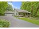 Inviting home with a covered front porch, attached two-car garage, mature shade trees, and a well-manicured lawn at 10808 Greenbriar Dr, Fishers, IN 46037