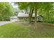 Inviting home featuring a covered front porch, attached two-car garage, and mature shade trees at 10808 Greenbriar Dr, Fishers, IN 46037
