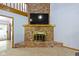 Brick fireplace with brass details beneath a wall mounted television at 10808 Greenbriar Dr, Fishers, IN 46037