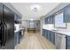 Kitchen with stainless steel appliances, white subway tile backsplash, and wood floors at 10808 Greenbriar Dr, Fishers, IN 46037