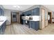 Updated kitchen with light wood floors, blue cabinets, and subway tile backsplash at 10808 Greenbriar Dr, Fishers, IN 46037