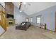 Spacious living room showcasing a comfortable sectional sofa, fireplace, and ample natural light at 10808 Greenbriar Dr, Fishers, IN 46037