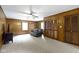 Living room with carpeting, windows, and paneled walls at 10808 Greenbriar Dr, Fishers, IN 46037