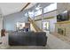 Open living room with exposed beams, fireplace, and a large sectional sofa at 10808 Greenbriar Dr, Fishers, IN 46037