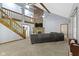 Open living room with exposed beams, fireplace, and a large sectional sofa at 10808 Greenbriar Dr, Fishers, IN 46037