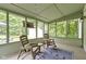 Relaxing screened-in porch with comfortable seating and string lights at 10808 Greenbriar Dr, Fishers, IN 46037