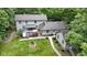 Beautiful two-story home with a spacious wooden deck and well-manicured lawn surrounded by lush trees at 10808 Greenbriar Dr, Fishers, IN 46037