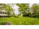 Beautiful backyard with mature trees, lush lawn, and view of home's exterior at 11875 Durbin Dr, Carmel, IN 46032
