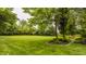 Expansive green backyard with mature trees and beautiful landscaping at 11875 Durbin Dr, Carmel, IN 46032