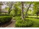 Spacious backyard with a stone path, beautiful landscaping and mature trees at 11875 Durbin Dr, Carmel, IN 46032