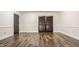Basement with hardwood floors and recessed lighting, multiple dark louvered doors with white trim at 11875 Durbin Dr, Carmel, IN 46032