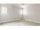 Empty bedroom with neutral carpet and white walls and trim, featuring two windows with white shutters at 11875 Durbin Dr, Carmel, IN 46032