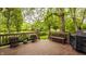 Spacious wooden deck with potted plants and a beautiful view of the lush green backyard at 11875 Durbin Dr, Carmel, IN 46032
