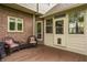 Cozy deck area with wicker chairs, perfect for relaxing outdoors near brick home at 11875 Durbin Dr, Carmel, IN 46032