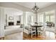 Cozy dining area with built-in bench seating and a view of the living room at 11875 Durbin Dr, Carmel, IN 46032