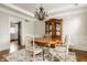 Traditional dining room featuring a wooden table, ornate hutch, and decorative chandelier at 11875 Durbin Dr, Carmel, IN 46032