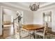 Elegant dining room with wainscoting, chandelier, and views to the staircase and living room at 11875 Durbin Dr, Carmel, IN 46032