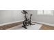 Workout room featuring stationary exercise bike with adjustable handlebars and console, set on a grey rug at 11875 Durbin Dr, Carmel, IN 46032