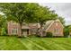 Lovely two-story brick home featuring manicured lawn and mature trees in a peaceful neighborhood setting at 11875 Durbin Dr, Carmel, IN 46032