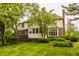 Spacious backyard featuring a multi-level deck, screened porch, beautiful landscaping, and a lush lawn at 11875 Durbin Dr, Carmel, IN 46032