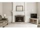 Elegant fireplace with detailed mantle and brick surround with modern television at 11875 Durbin Dr, Carmel, IN 46032