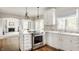 Bright kitchen featuring stainless steel appliances, white cabinets, and an open concept design at 11875 Durbin Dr, Carmel, IN 46032