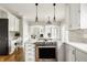 Gourmet kitchen with stainless steel appliances, white cabinets, a large island, and eat-in area at 11875 Durbin Dr, Carmel, IN 46032