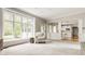 Open-concept living room with a large window and seamless flow to the kitchen at 11875 Durbin Dr, Carmel, IN 46032