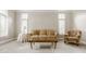 Comfortable living room with a plush sofa, patterned armchair, and natural light at 11875 Durbin Dr, Carmel, IN 46032
