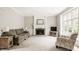 Inviting living room with a fireplace, large windows, and neutral decor at 11875 Durbin Dr, Carmel, IN 46032