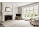 Bright living room with a large bay window, neutral carpet, and fireplace at 11875 Durbin Dr, Carmel, IN 46032