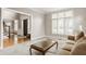 Inviting living room with plush carpeting, neutral tones, and natural light streaming through large windows at 11875 Durbin Dr, Carmel, IN 46032
