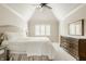 Serene main bedroom featuring vaulted ceiling, plush carpet, and ample natural light from the shuttered window at 11875 Durbin Dr, Carmel, IN 46032