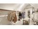 Spacious walk-in closet with custom shelving, ample storage, and a comfortable seating area at 11875 Durbin Dr, Carmel, IN 46032