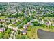 Aerial view of a well-planned neighborhood with mature trees, manicured lawns, and community ponds at 12635 Tuscany Blvd, Carmel, IN 46032