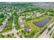 Aerial view of homes in a scenic neighborhood with a pond, tree-lined streets, and manicured lawns at 12635 Tuscany Blvd, Carmel, IN 46032