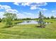 Backyard view of pond with trees at 12635 Tuscany Blvd, Carmel, IN 46032