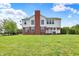 Exterior backyard showing ample grass, large windows, and white deck at 12635 Tuscany Blvd, Carmel, IN 46032