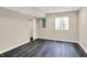 View of the basement bedroom with egress window and modern gray vinyl flooring at 12635 Tuscany Blvd, Carmel, IN 46032