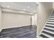 Finished basement with dark wood-look flooring and staircase at 12635 Tuscany Blvd, Carmel, IN 46032