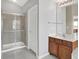 Bathroom featuring a tiled shower with glass doors, vanity with solid surface counters, and neutral paint at 12635 Tuscany Blvd, Carmel, IN 46032