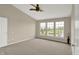 Spacious bedroom with vaulted ceilings and three windows overlooking a scenic pond at 12635 Tuscany Blvd, Carmel, IN 46032