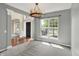 Open dining room with gray walls, neutral carpet, and view of the front yard at 12635 Tuscany Blvd, Carmel, IN 46032
