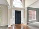 Inviting entryway with hardwood floors, grand pillars and a striking black door flanked by sidelights at 12635 Tuscany Blvd, Carmel, IN 46032