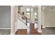 A welcoming foyer, featuring hardwood floors and an oak staircase with a view into the living spaces at 12635 Tuscany Blvd, Carmel, IN 46032