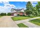View of this lovely home with a three car garage, lush lawn and landscaping, side view at 12635 Tuscany Blvd, Carmel, IN 46032