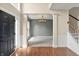 Spacious foyer showcasing gleaming hardwood floors, elegant pillars, and a glimpse into the adjacent living spaces at 12635 Tuscany Blvd, Carmel, IN 46032