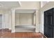 Beautiful open foyer featuring gleaming hardwood floors, decorative pillars, and a view to the entryway at 12635 Tuscany Blvd, Carmel, IN 46032