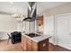 Kitchen with island, stainless hood, cooktop, and wooden floors at 12635 Tuscany Blvd, Carmel, IN 46032